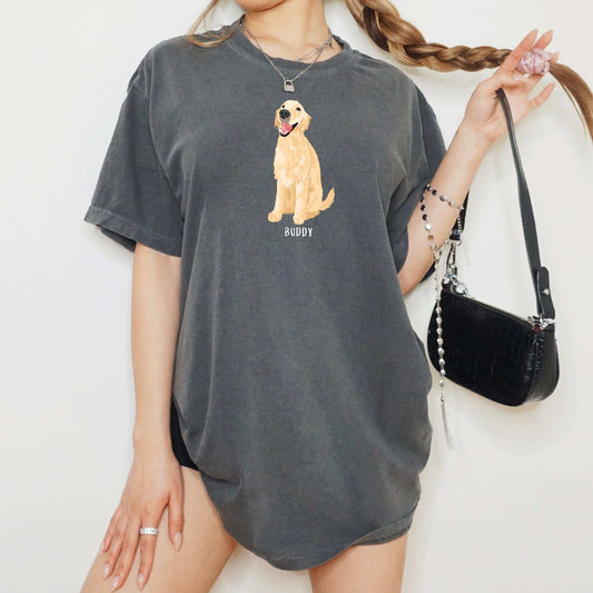A young woman wearing a personalized Golden Retriever t-shirt in color pepper with a golden retriever graphic and dogs name underneath from Love Dogs Gifts
