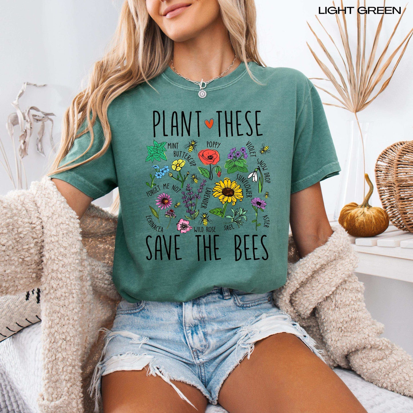 A woman wearing a cottagecore aesthetic shirt with plant these save the bees shirt design