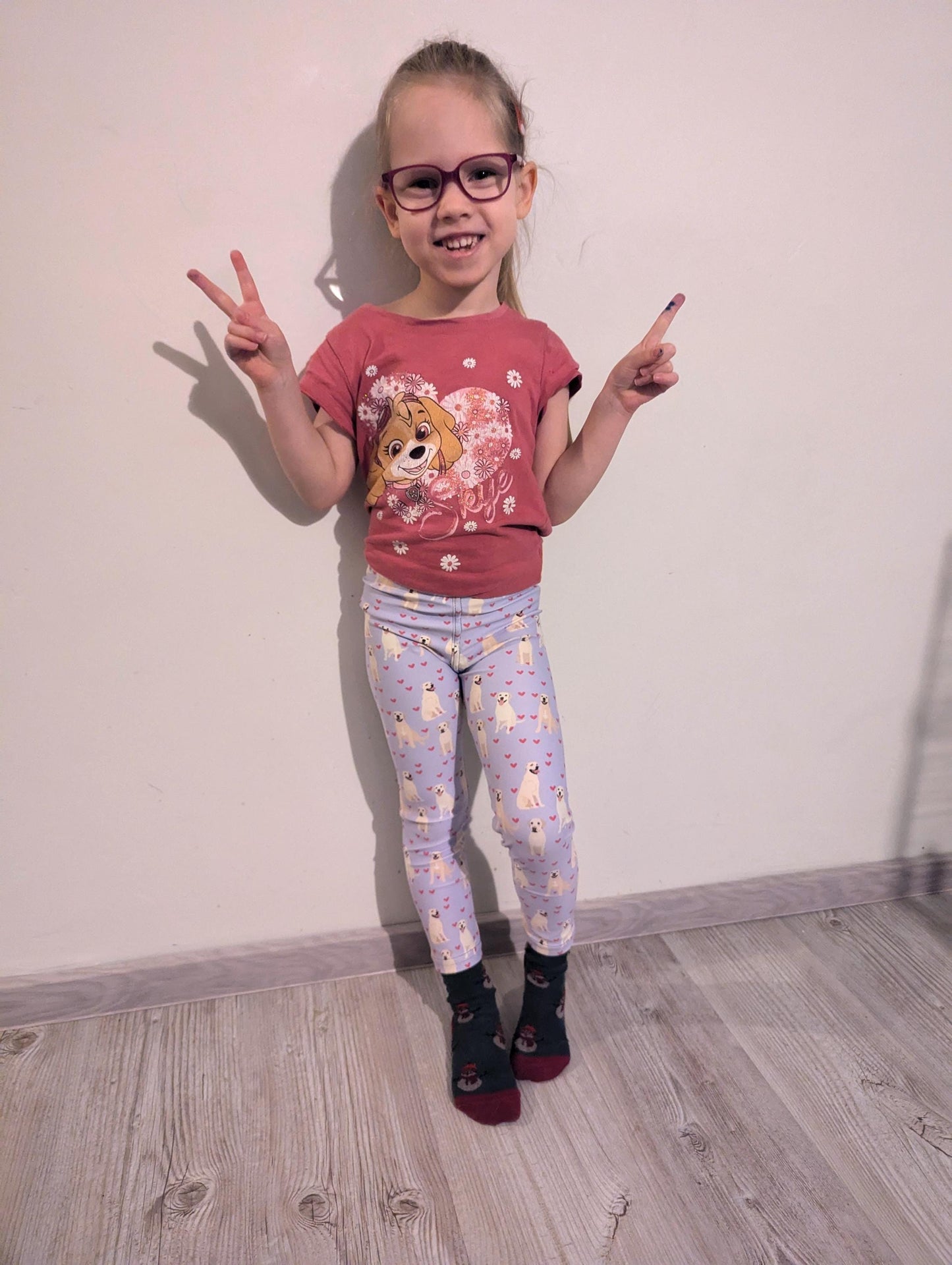 a girl wearing yellow labrador puppy leggings