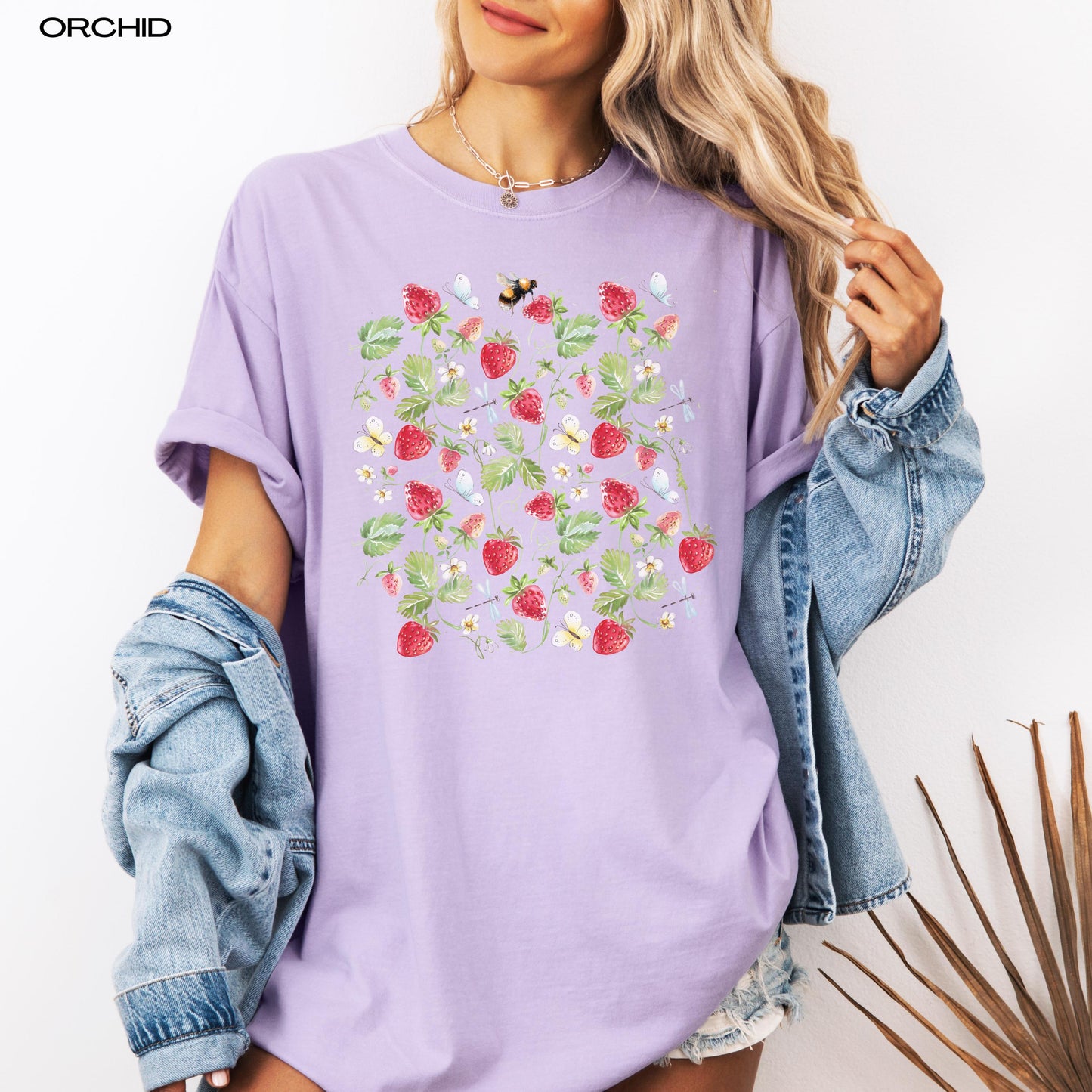 Fresh wild strawberries comfort colors 1717 orchid t-shirt on a women with a denim jacket