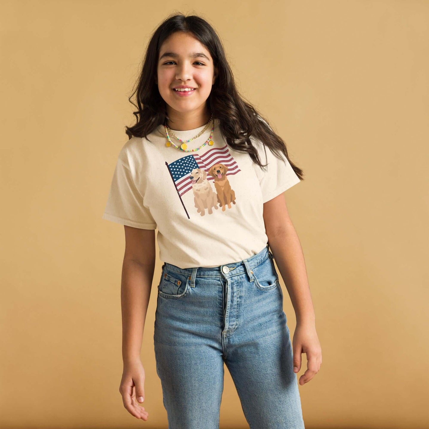 A young girl wearing 4th of July Golden Retriever youth t-shirt in color natural.
