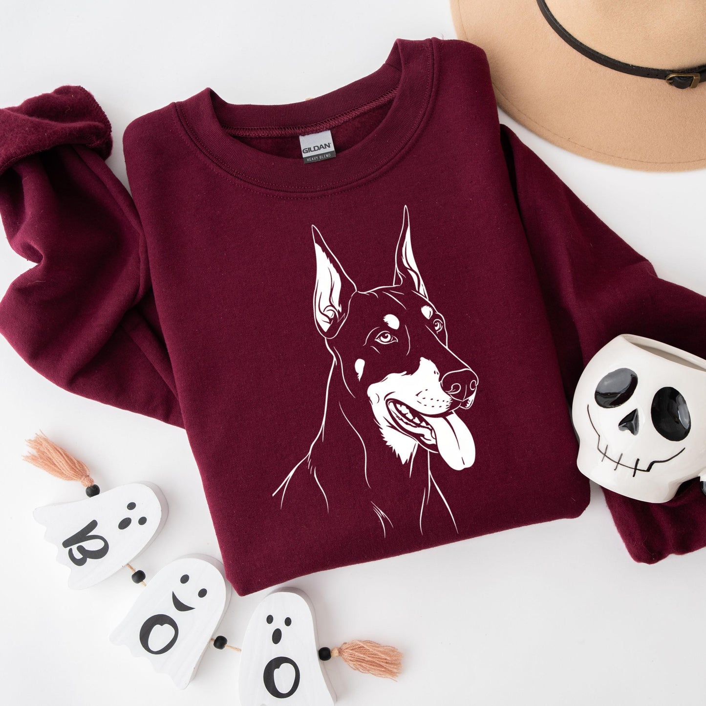 Doberman Silhouette Sweatshirt: Unisex Pinscher Lover Gift with white artwork on a burgundy background.