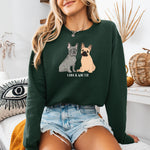 A dog mom wearing a personalized French Bulldog sweatshirt  in color forest green with grey frenchie and a tan frenchie, and their names underneath the dog graphic