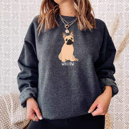 A dog person wearing a personalized French Bulldog sweatshirt  in color dark heather with a tan frenchie, and a dogs name underneath the dog graphic