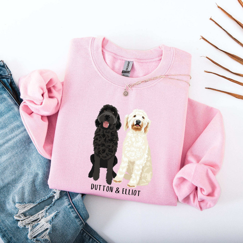 Personalized Goldendoodle light pink sweatshirt with a design of a black goldendoodle and a white goldendoodle from Love Dogs Gifts dog owner gift store