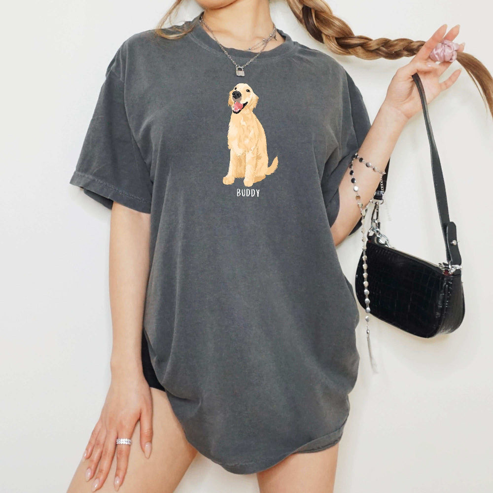 A young woman wearing a personalized Golden Retriever t-shirt in color pepper with a golden retriever graphic and dogs name underneath from Love Dogs Gifts