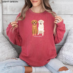 A dog mom wearing a personalized Golden Retriever sweatshirt in color crimson from Love Dogs Gifts