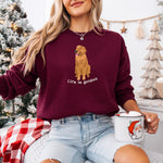 A dog mom wearing a sweatshirt in color maroon with a red golden retriever and a text "Life is Golden" from Love Dogs Gifts store
