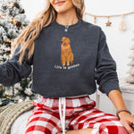 A woman wearing a sweatshirt with a red golden retriever and a text "Life is Golden" from Love Dogs Gifts store