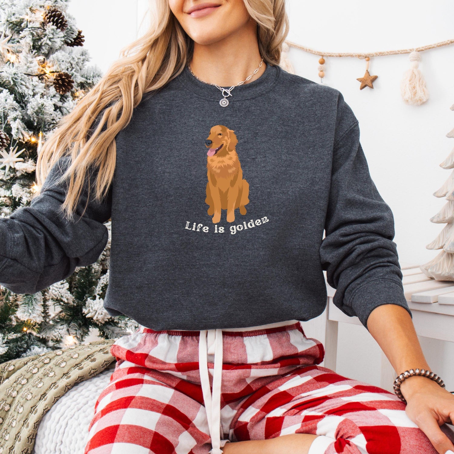 A woman wearing a sweatshirt with a red golden retriever and a text "Life is Golden" from Love Dogs Gifts store