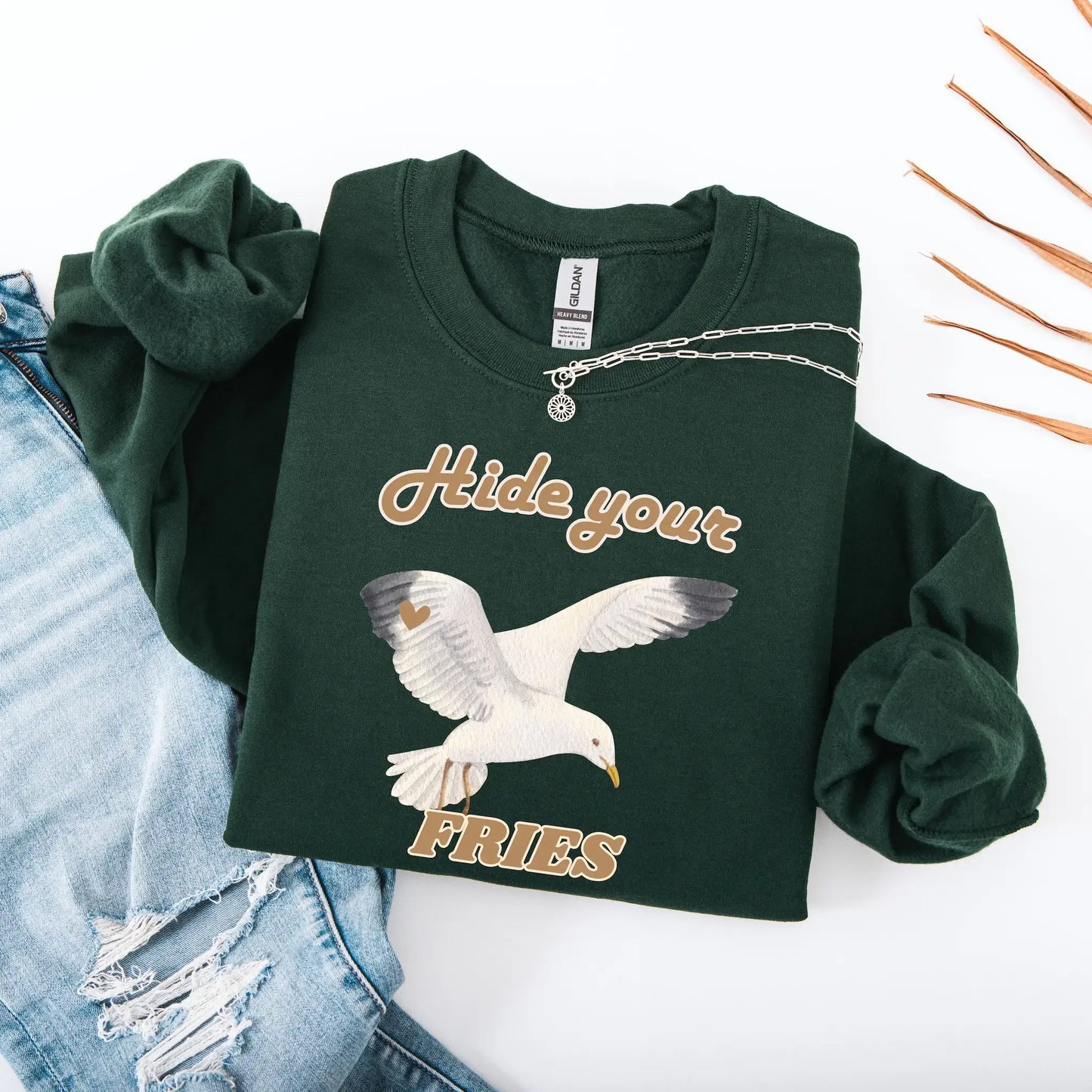 Green sweatshirt with a seagull graphic and text 'Hide your FRIES'.