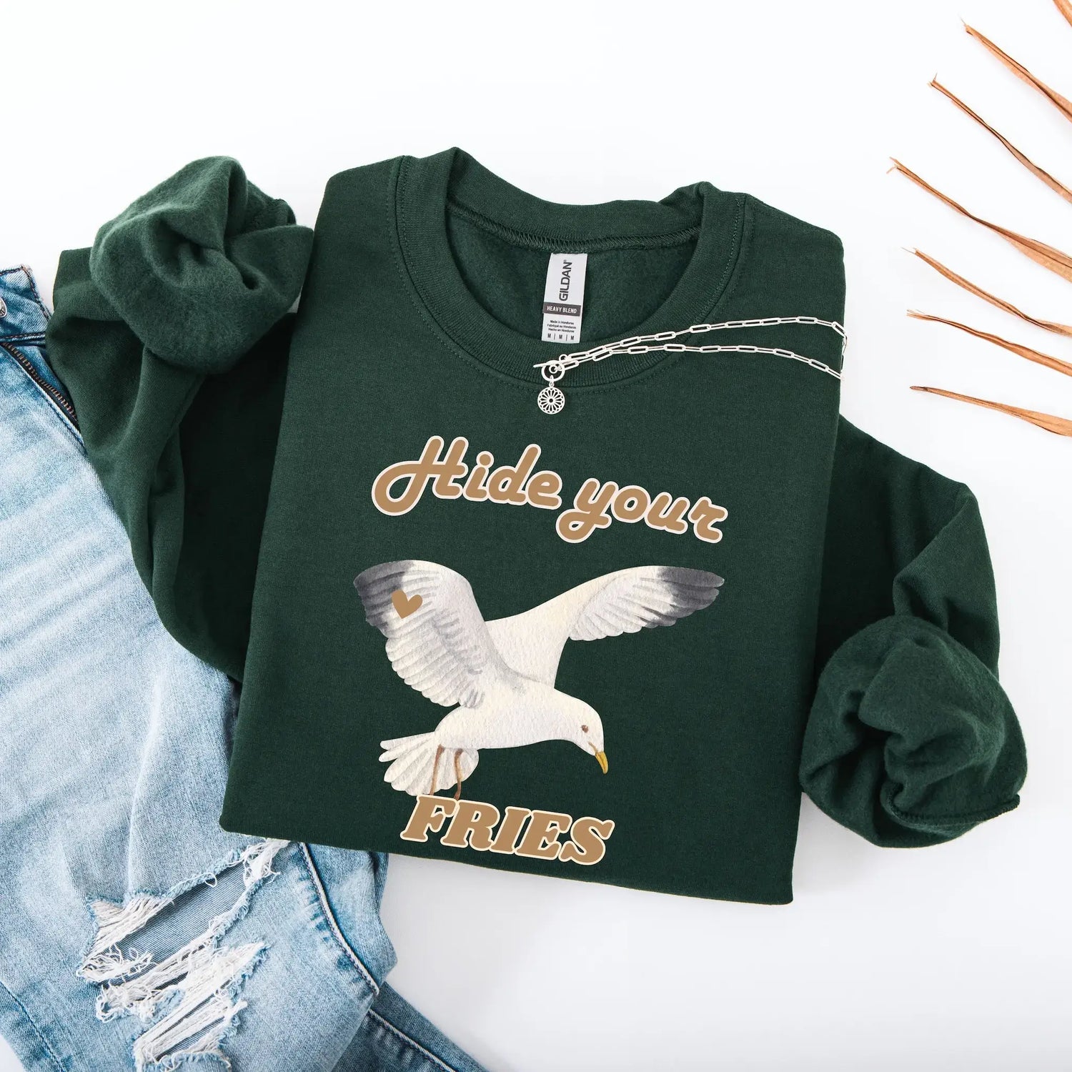 Green sweatshirt with a seagull graphic and text 'Hide your FRIES'.