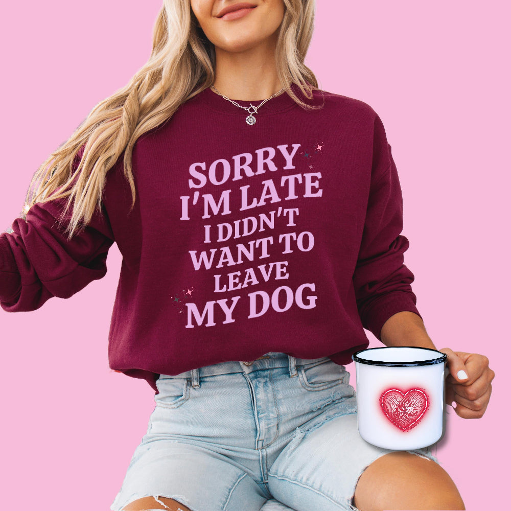 A dog mom wearing a sweatshirt in color burgundy with the lavander colored text "Sorry I'm Late I Didn't Want to Leave My Dog" from Love Dogs Gifts