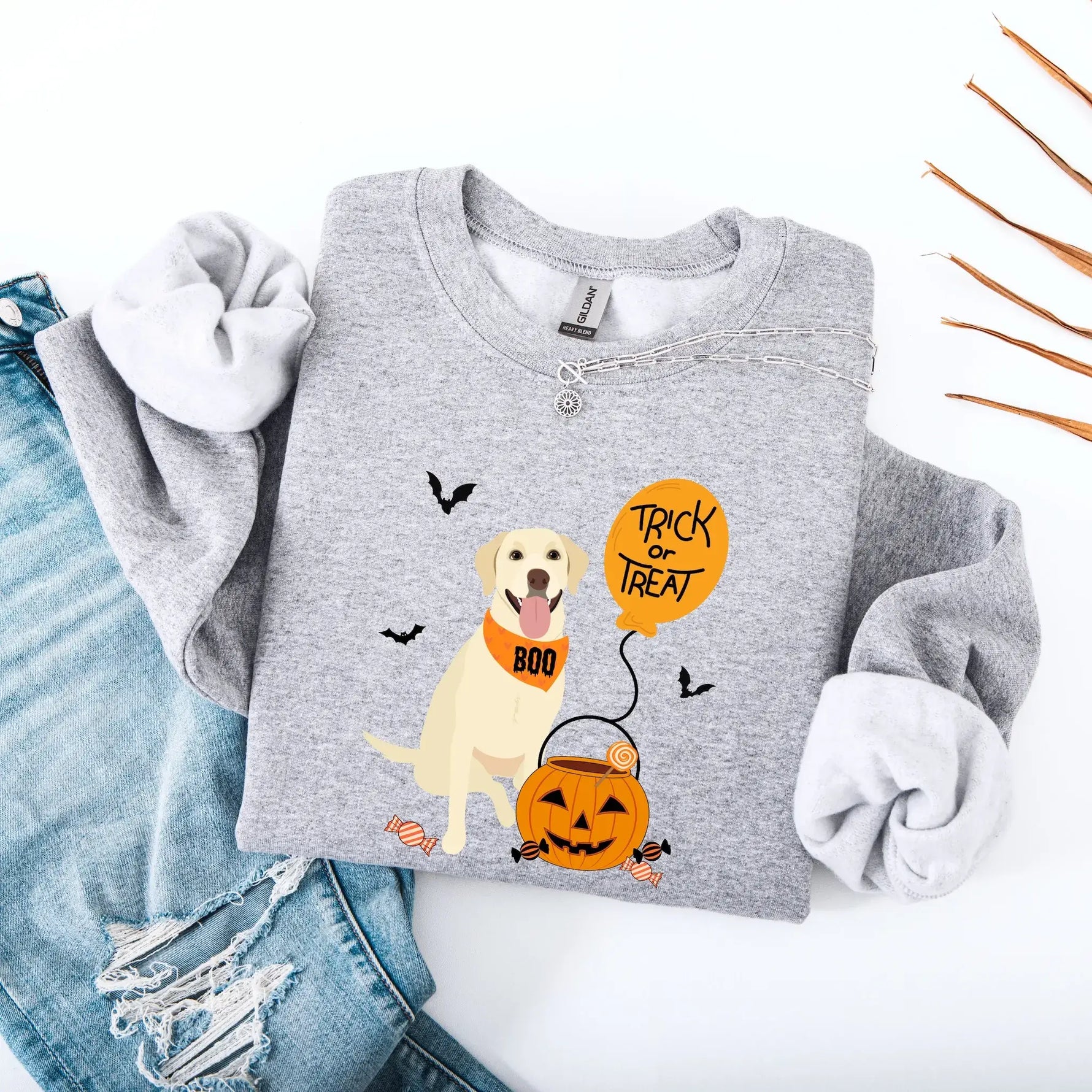 Gray sweatshirt with Halloween-themed design featuring a labrador retriever dog with a bandana Boo, pumpkin, and balloon with a text Trick or Treat