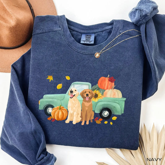 Navy comfort colors sweatshirt with a graphic of two golden retrievers next to a truck with pumpkins and leaves.