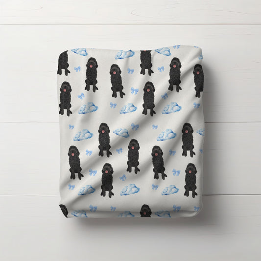 Black Golden doodle baby minky blanket with blue clouds bows flat lay view