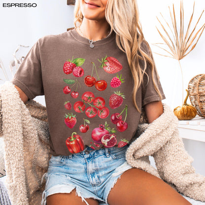 A woman wearing fresh produce strawberry cherry raspberry tomatoe pomegranate red bell pepper shirt