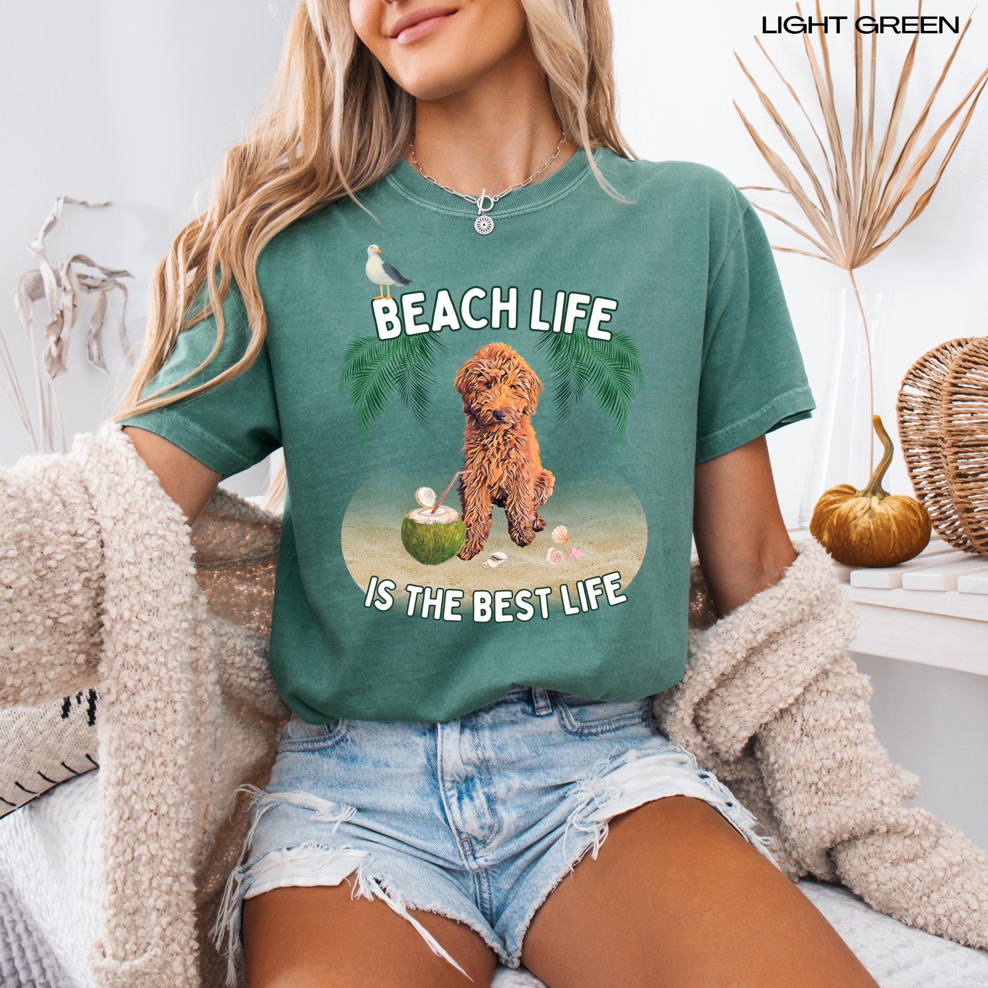 A woman wearing a beach life is the best life Golden Doodle dog shirt