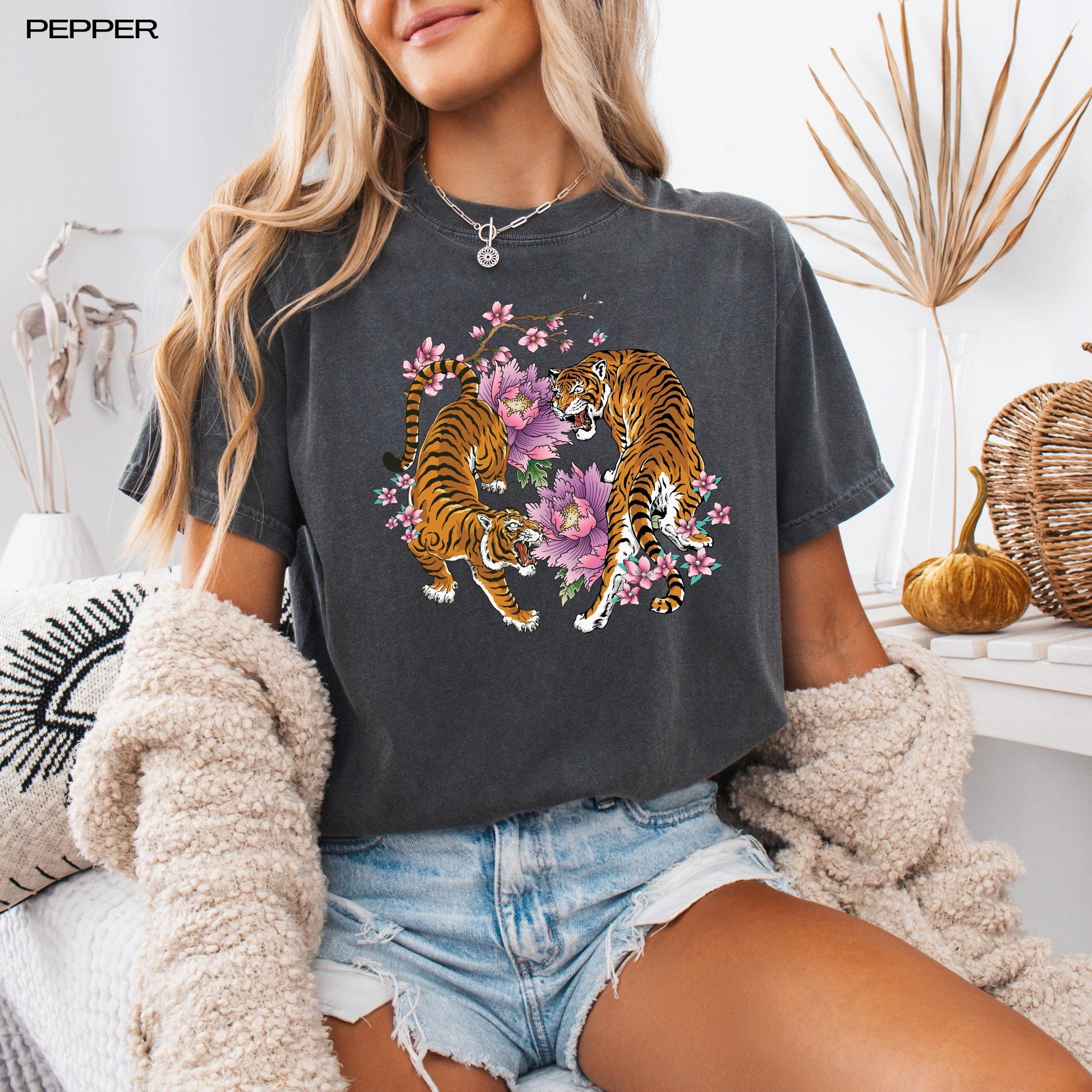 A woman wearing a unisex floral tiger sakura shirt