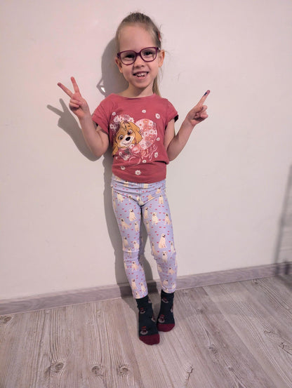 a girl wearing yellow labrador puppy leggings