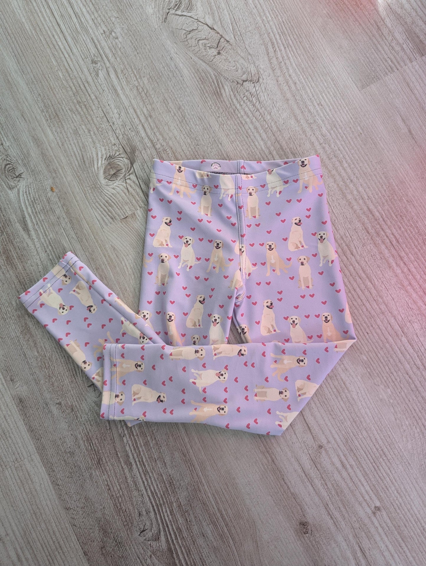 a flatlay view of a yellow labrador puppy leggings for kids