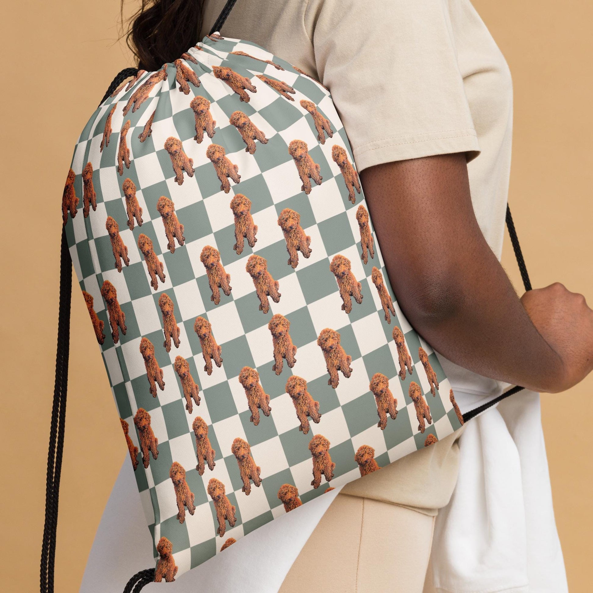 A woman wearing a retro checkered red Golden doodle drawstring bag