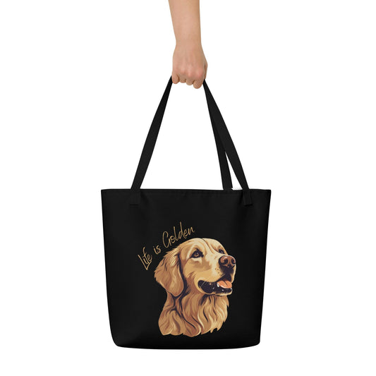 A hand holding a Life Is Golden Dog Mom Tote Bag