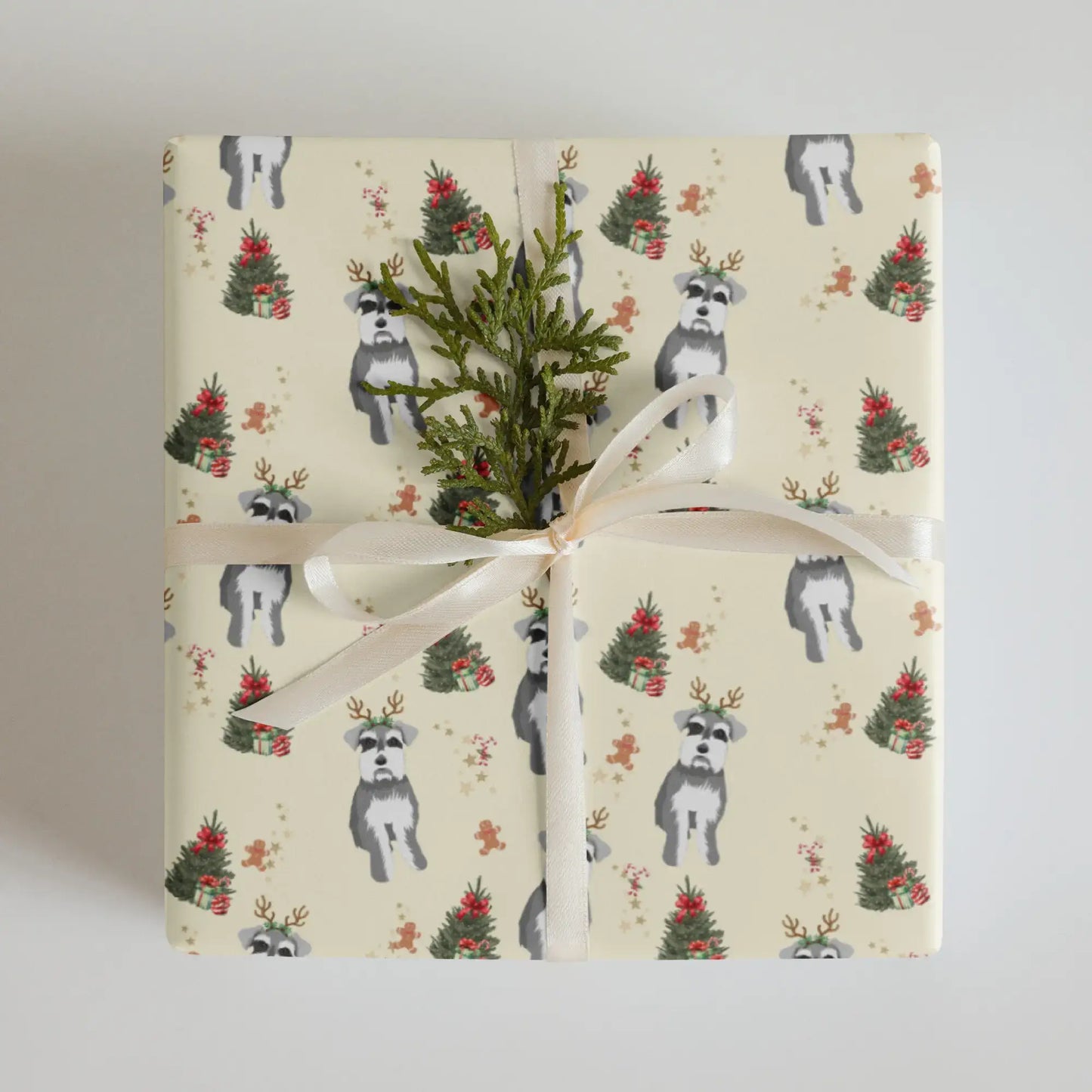 Gift wrapped in a Christmas wrapping paper with dogs, miniature schnauzer and Christmas tree pattern on a neutral background