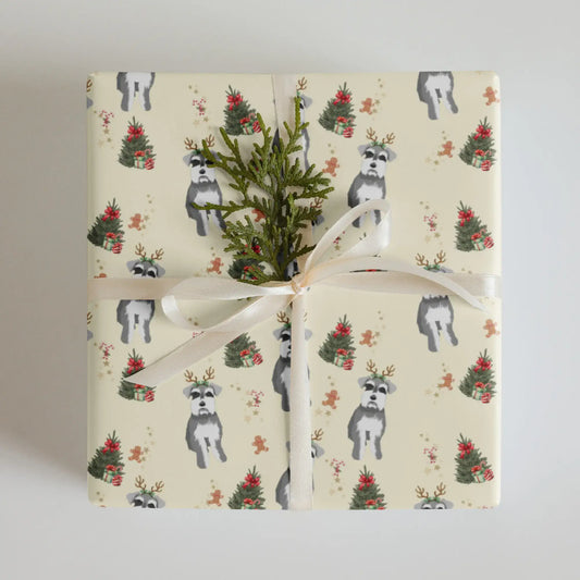 Gift wrapped in a Christmas wrapping paper with dogs, miniature schnauzer and Christmas tree pattern on a neutral background
